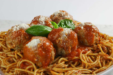 Delicious homemade spaghetti and meatballs topped with Gallo Tomato Basil Sauce and fresh basil leaves.