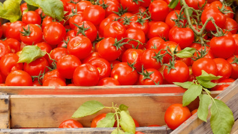 Vibrant San Marzano tomatoes spilling from a wooden crate.