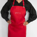 Bold red J'adore cooking apron with adjustable straps and deep pocket, perfect for home chefs in the kitchen.